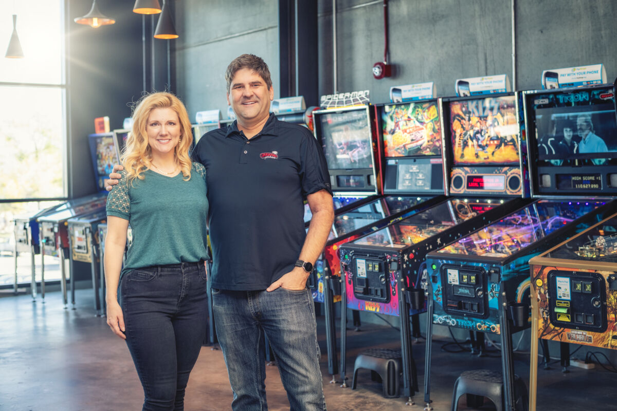 fargo pinball owners in front of machines
