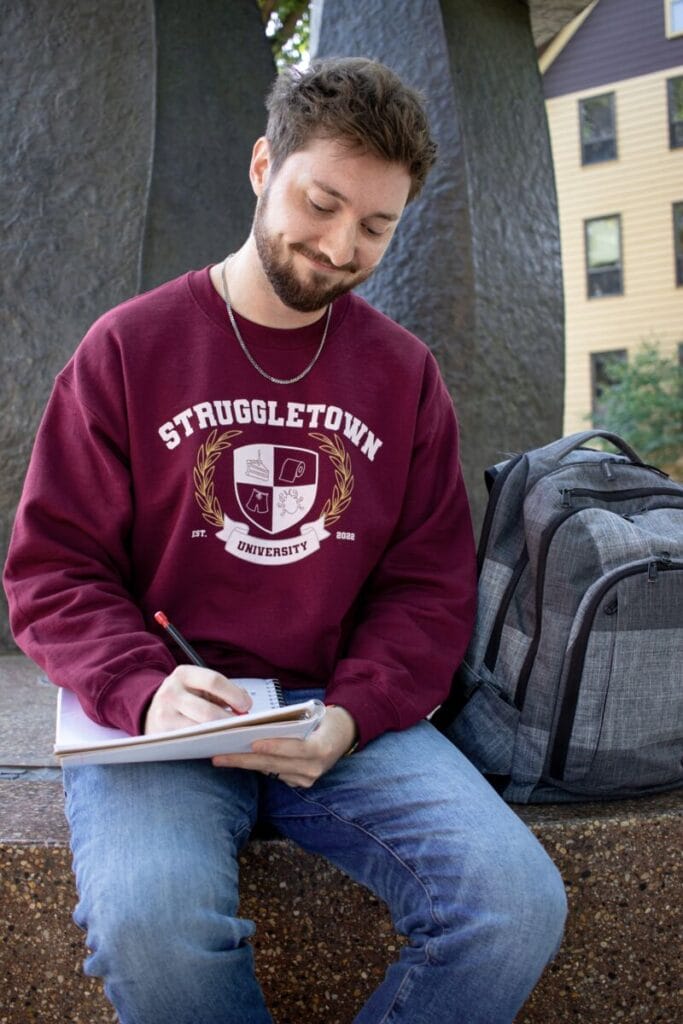 man writing in notebook