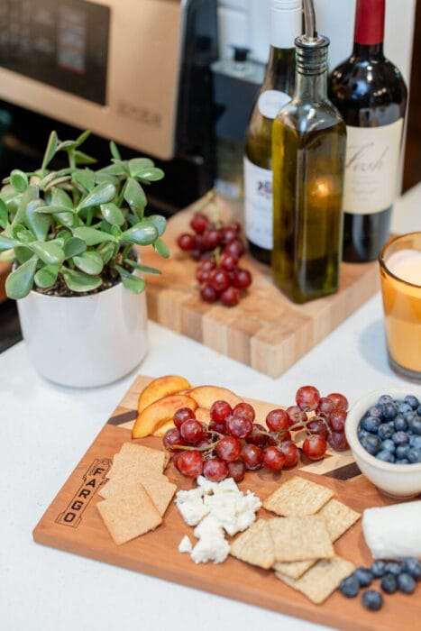 charcuterie board with cheese grapes etc
