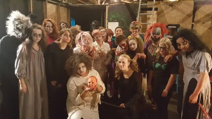 people in halloween costumes in haunted house