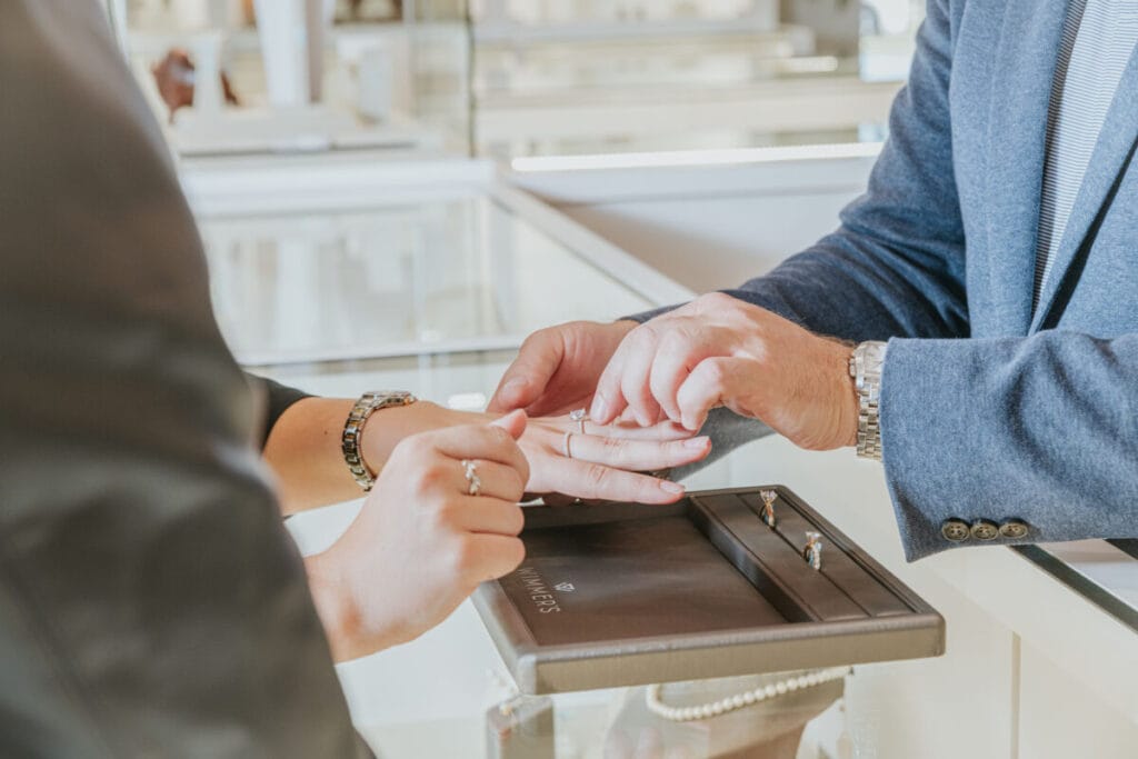 couple trying on wedding rings 2