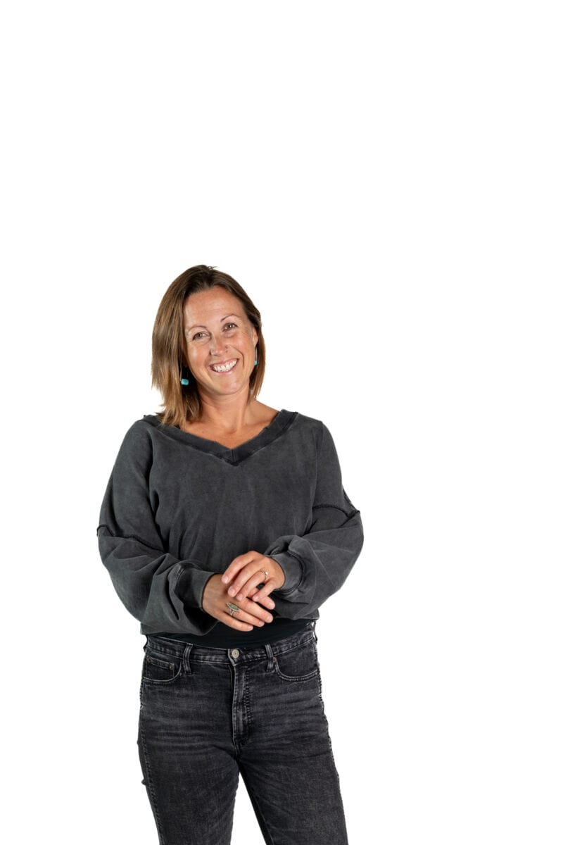 woman standing holding hands smiling