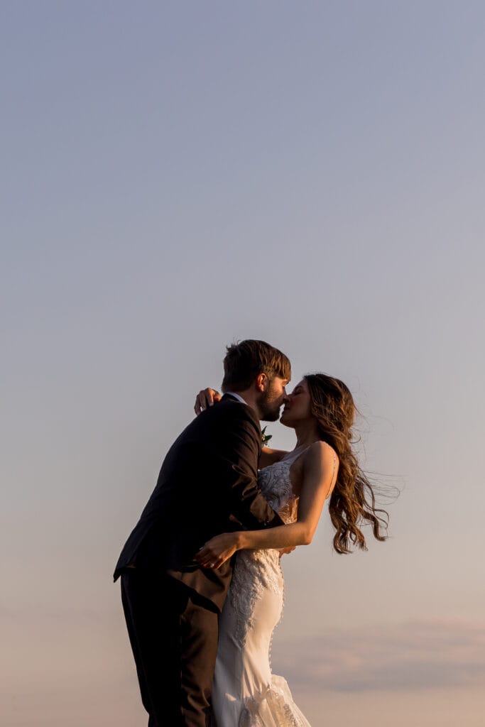 couple at wedding posed at sunset