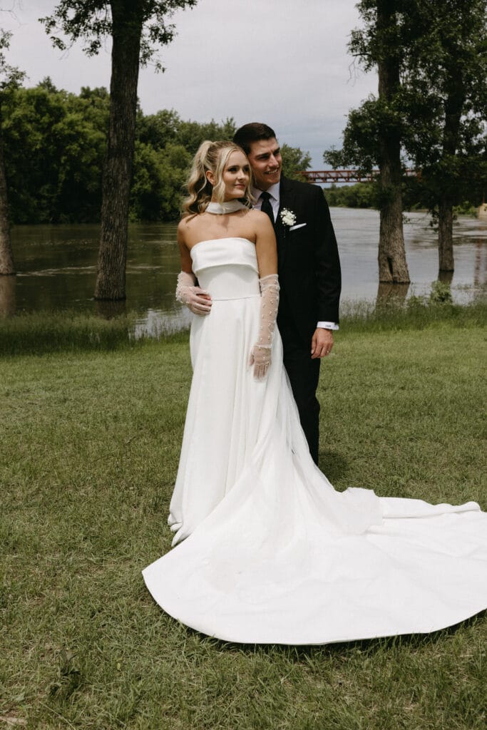 couple posing outside in wedding attire 2