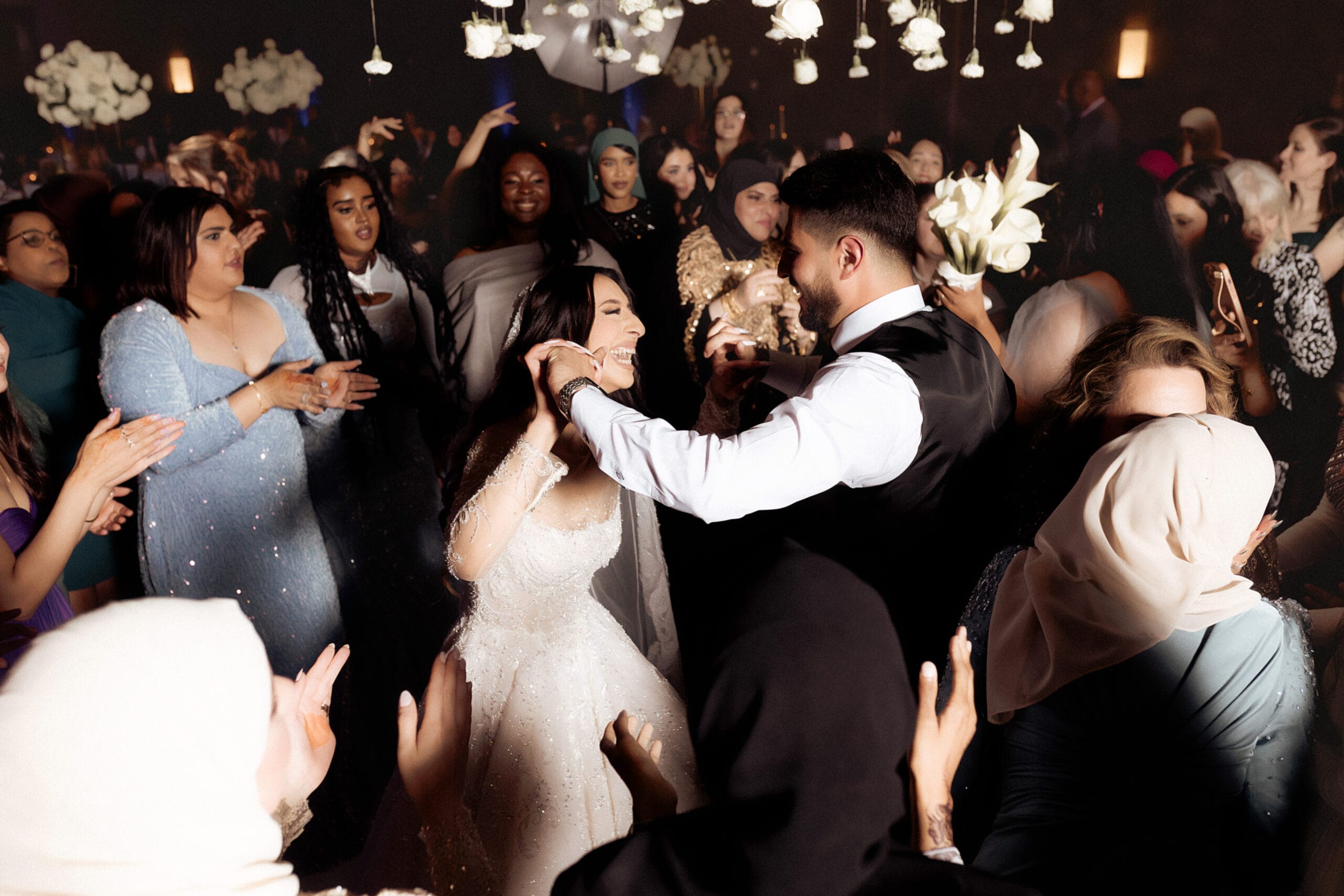 large group dancing and laughing at wedding scaled