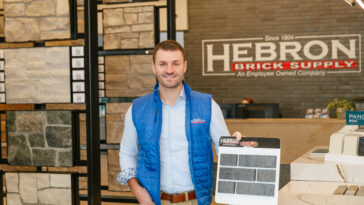 man holding brick samples in store