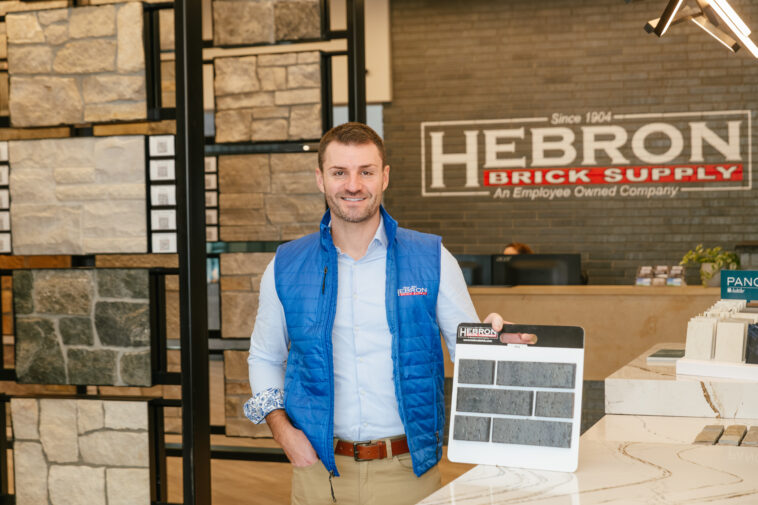 man holding brick samples in store