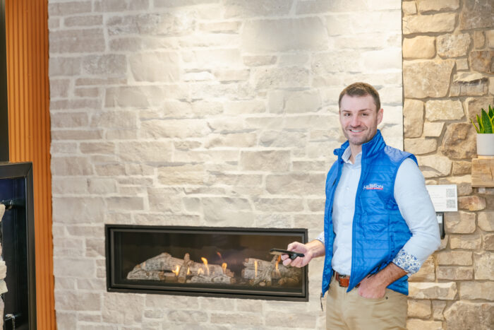 man smiling infront of fireplace 1