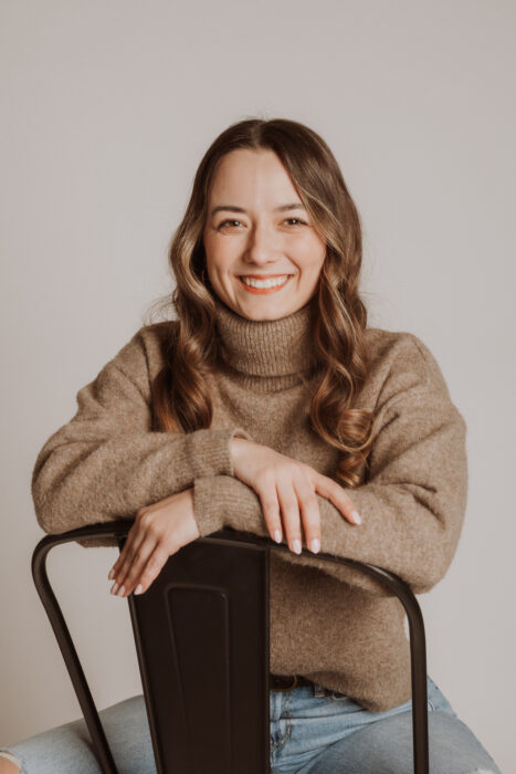 woman sitting backwards in chair smiling